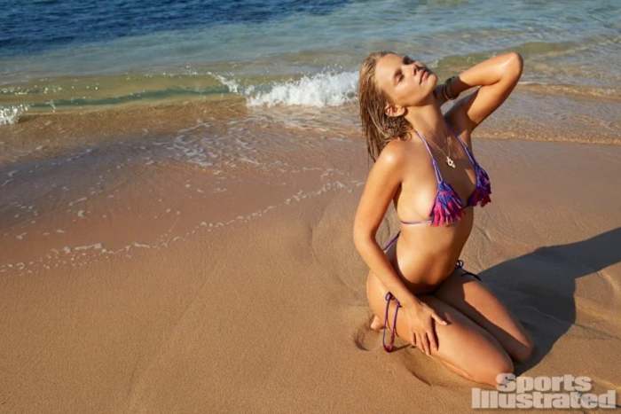 Marloes Horst sits on the beach in a vibrant triangle bikini set.